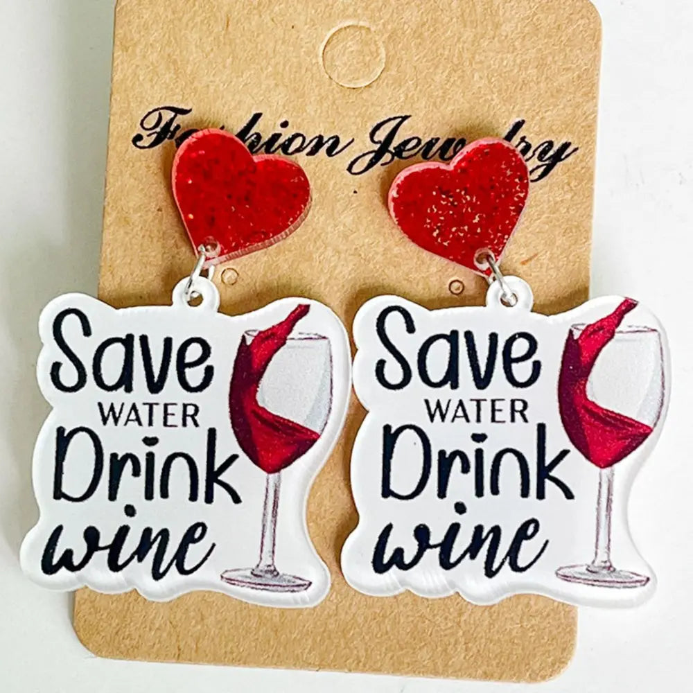 Festive acrylic drop earrings with red glitter hearts and "Save Water Drink Wine" text.