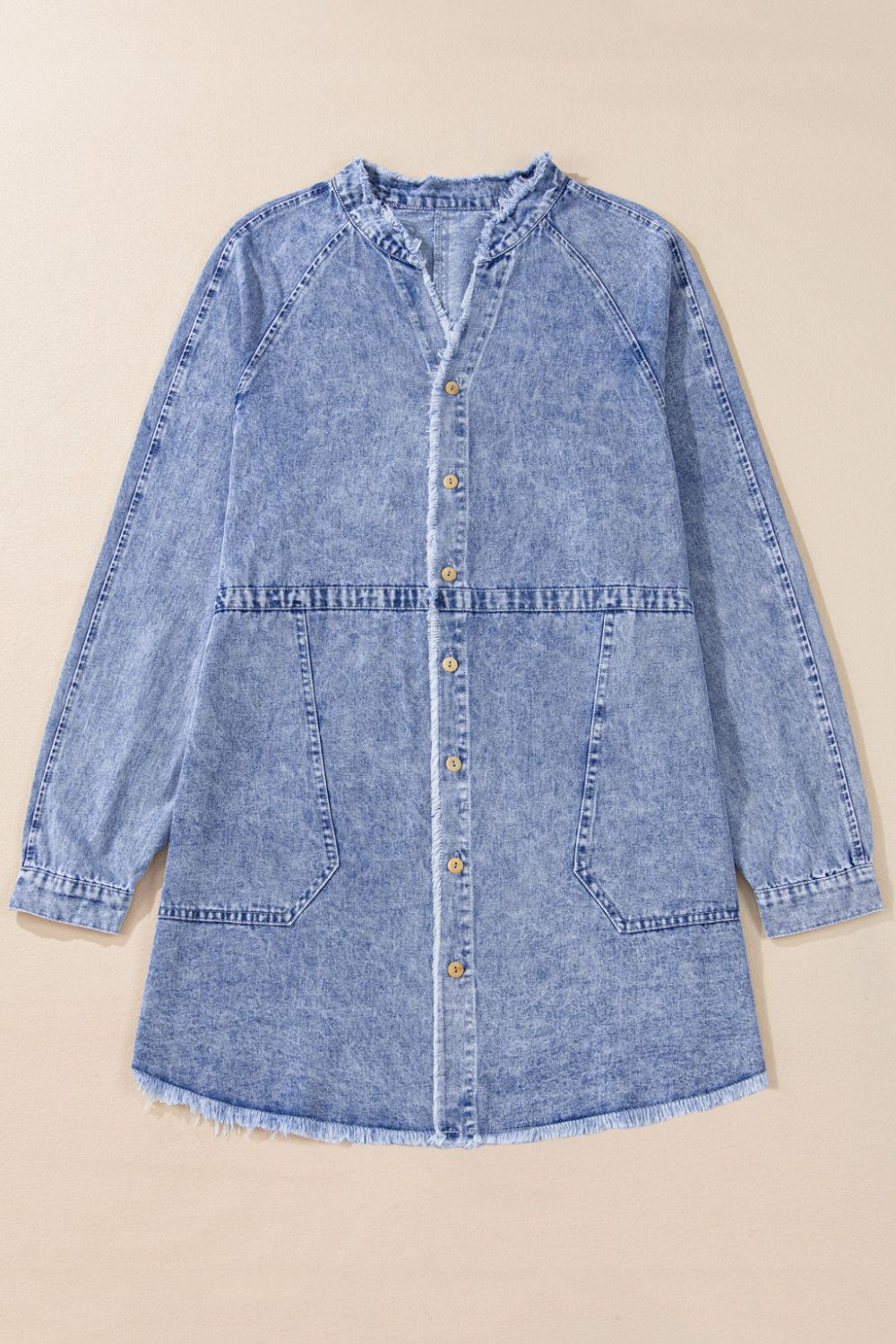 Acid wash denim shirtdress with raw hem, button front, and chest pockets.