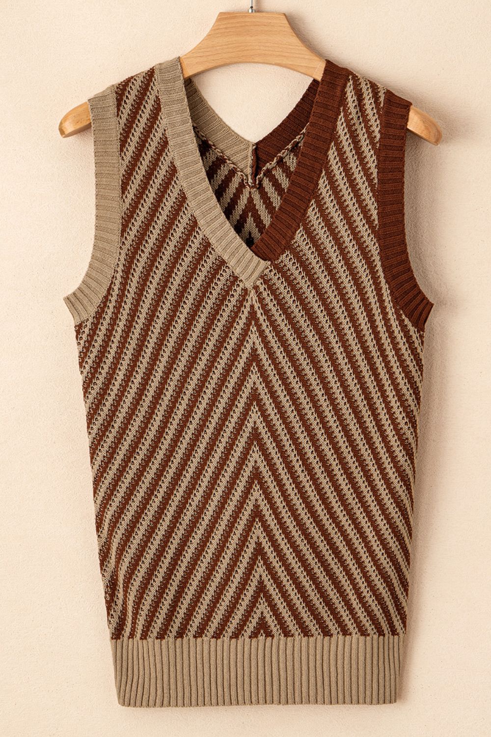Chevron knit vest in brown and tan with V-neck and open stitch detail.