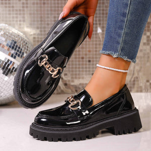 Gloss black chunky lug sole loafers with gold chain detail and platform sole.