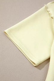 Light yellow mock neck two-piece set with dropped shoulders and lettuce trim detail.