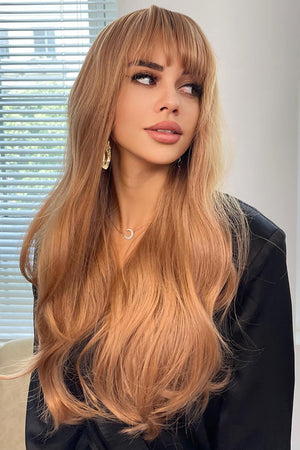 Strawberry blonde wig with baguette bangs and sunset waves, styled casually.
