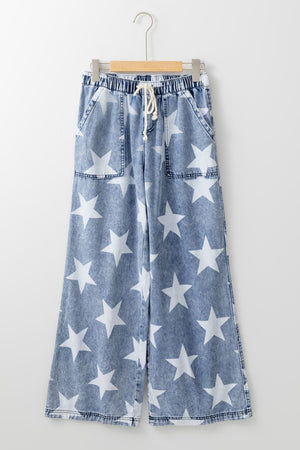 Cosmic Wash Star Print Palazzo Jeans in medium blue denim with white stars and a drawstring waist.