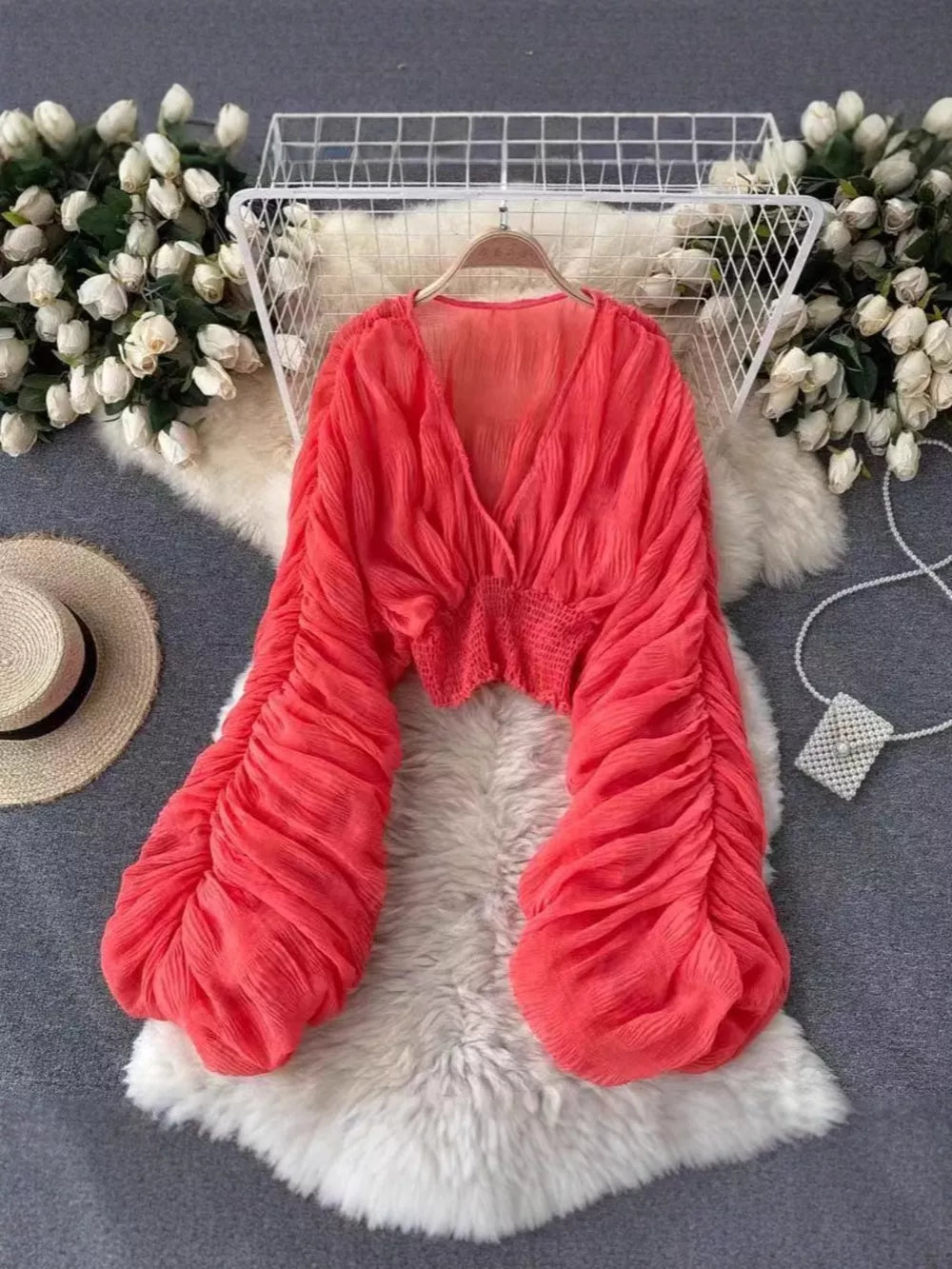 Voluminous ruched sleeve deep v-neck blouse in coral.