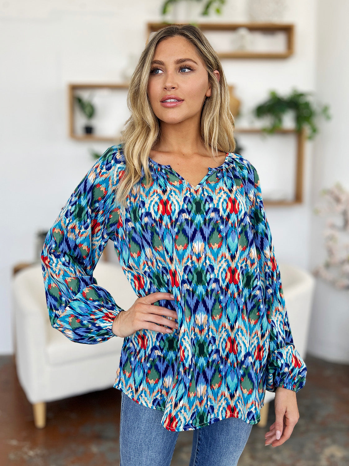 Prismatic ikat blouse with voluminous sleeves in blue and green, featuring a V-neck and gathered cuffs.