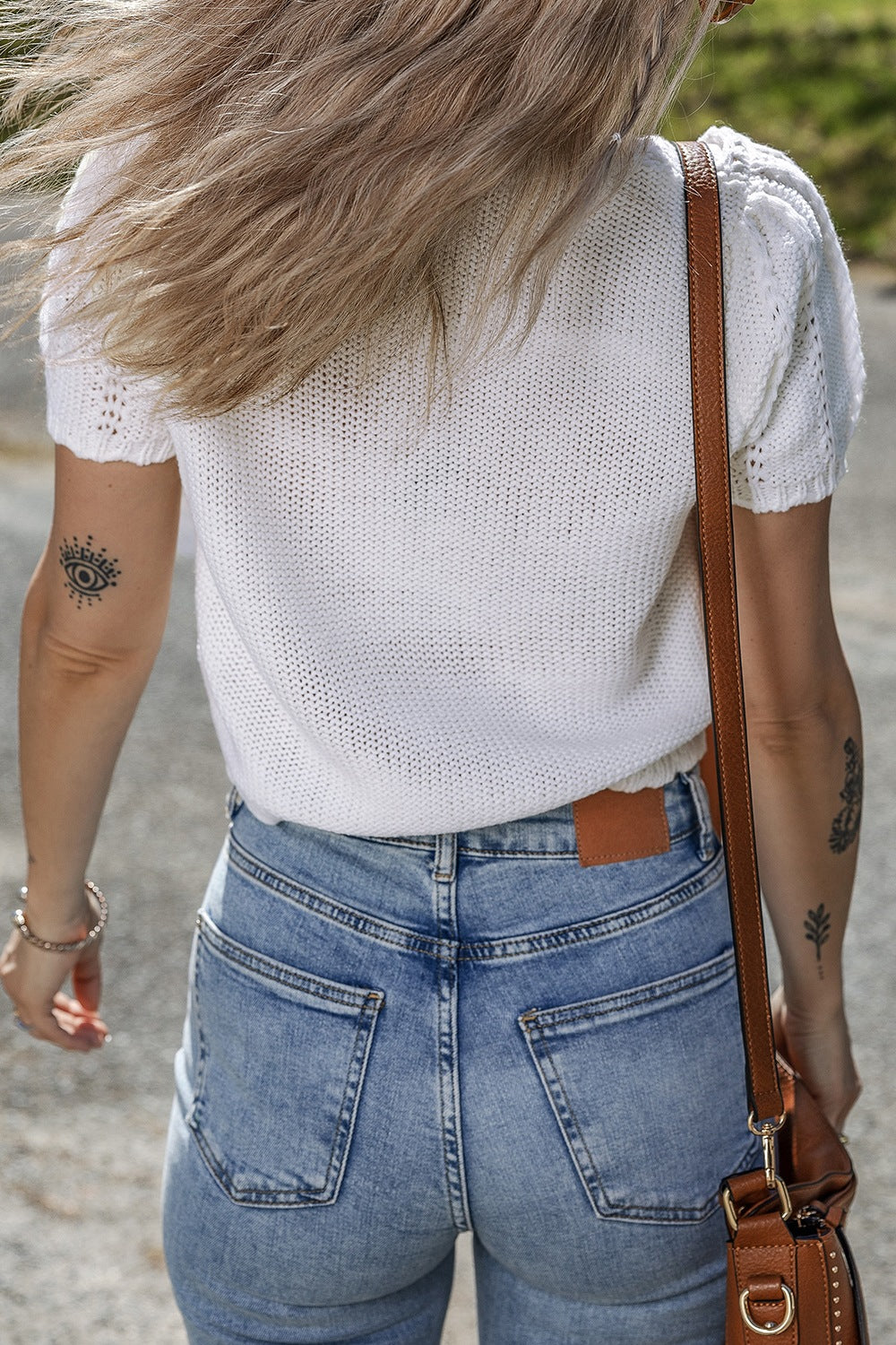 White eyelet knit puff sleeve top with textured sleeves and a crew neck.
