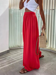 Red maternity pants with paperbag waist and adjustable fit, made of cotton.