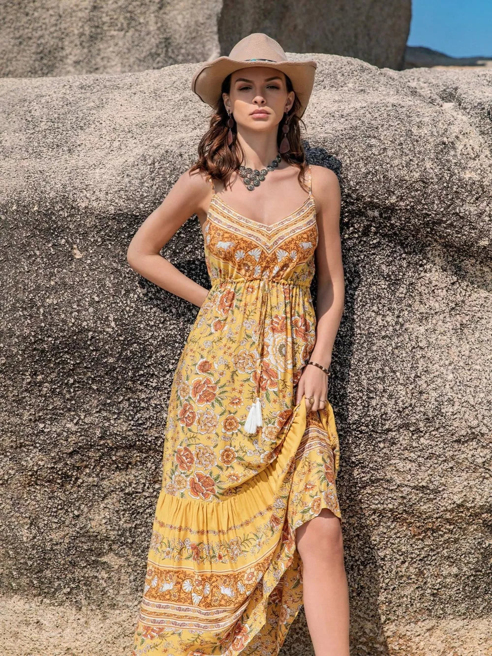 Yellow floral print cami maxi dress with tiered hem and tassel detail.