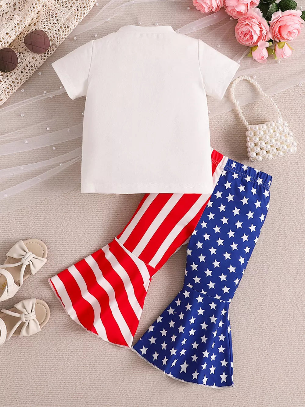 Patriotic toddler two-piece set with white tee and flared pants in red stripes and blue stars.