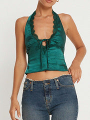 Deep teal satin halter top with lace trim and tie front detail.