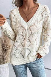 Ivory openwork knit v-neck pullover sweater with diamond pattern and ribbed trim.