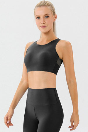 Black sports bra with mesh detail on sides and high neckline
