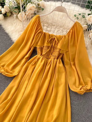 Yellow ruffled square neck maternity dress with smocked bodice and balloon sleeves.