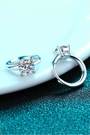 Silver hoop earrings with a solitaire diamond and halo detail.
