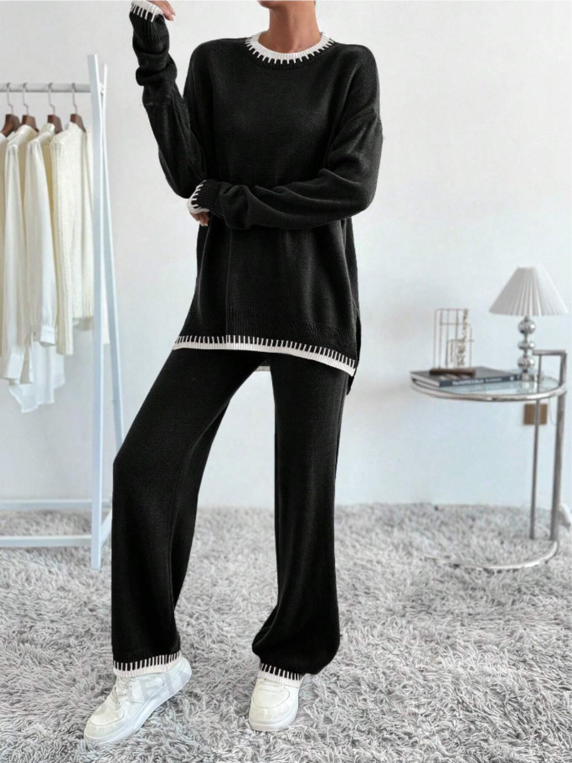 Black knit loungewear set with white contrast trim on neckline, cuffs, and hem.