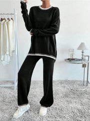 Black knit loungewear set with white contrast trim on neckline, cuffs, and hem.