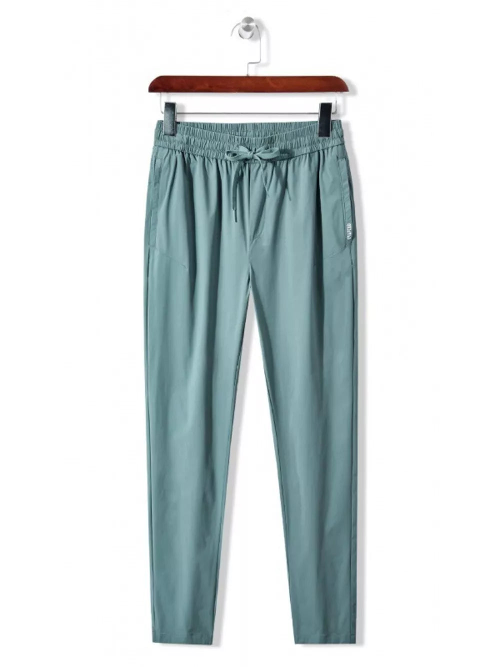 Men's turquoise drawstring active pants with elastic waistband and pockets.