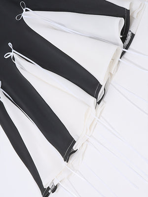 Black and white mini dress with bowknot details and tie accents.