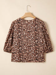 Leopard print blouse with puff sleeves and a cropped cut.