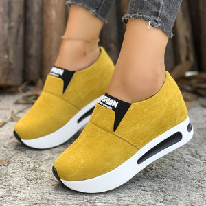 Yellow round toe platform slip-on sneakers with white soles and black accents.