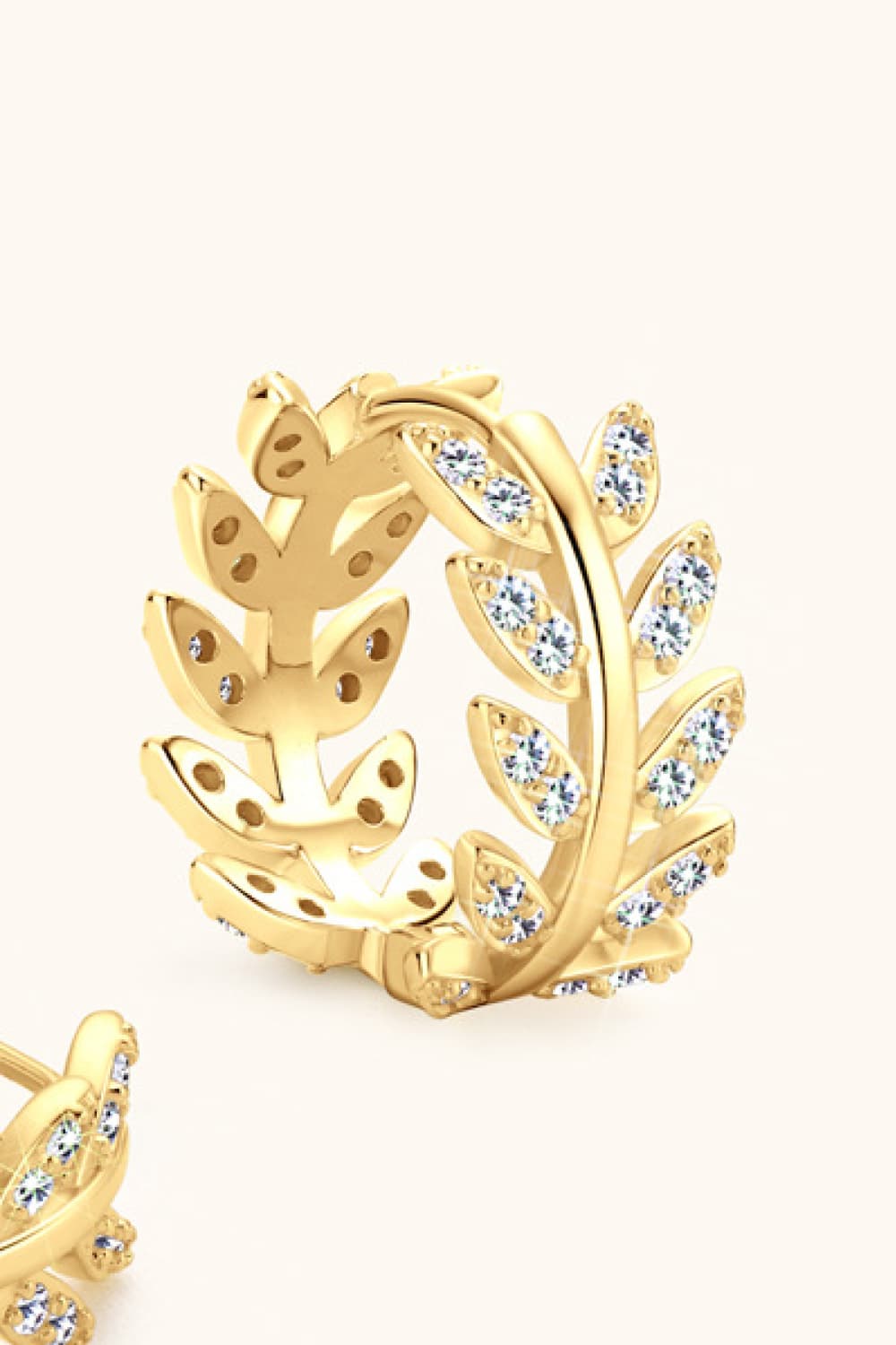 Gold pavé leaf hoop earrings with cubic zirconia accents.