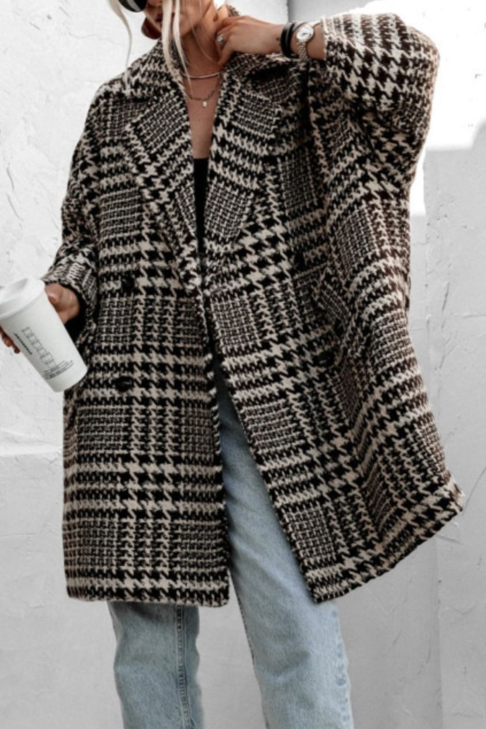 Oversized houndstooth cocoon coat in black and brown with a double-breasted closure.