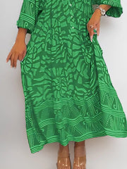 Green abstract print midi dress with 3/4 sleeves and pockets.