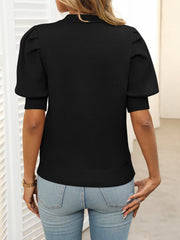 Black knit sweater with mock neck and puff short sleeves, ribbed cuffs and hem.