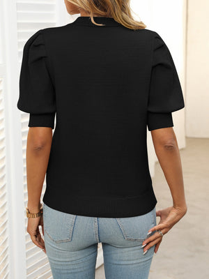 Black knit sweater with mock neck and puff short sleeves, ribbed cuffs and hem.