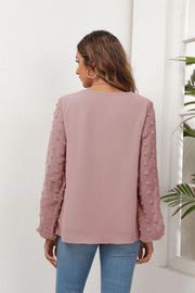 Dusty Pink V-neck blouse with textured pom-pom balloon sleeves.