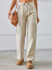Tan drawstring cargo wide-leg denim trousers with buttoned flap pockets.