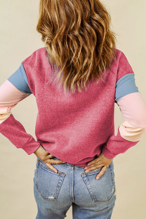 Colorblock sweatshirt in Dusty Pink with blue and light pink sleeves.