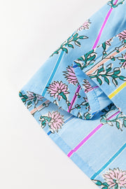 Sky blue floral print blouse with smocked yoke detail and striped pattern.