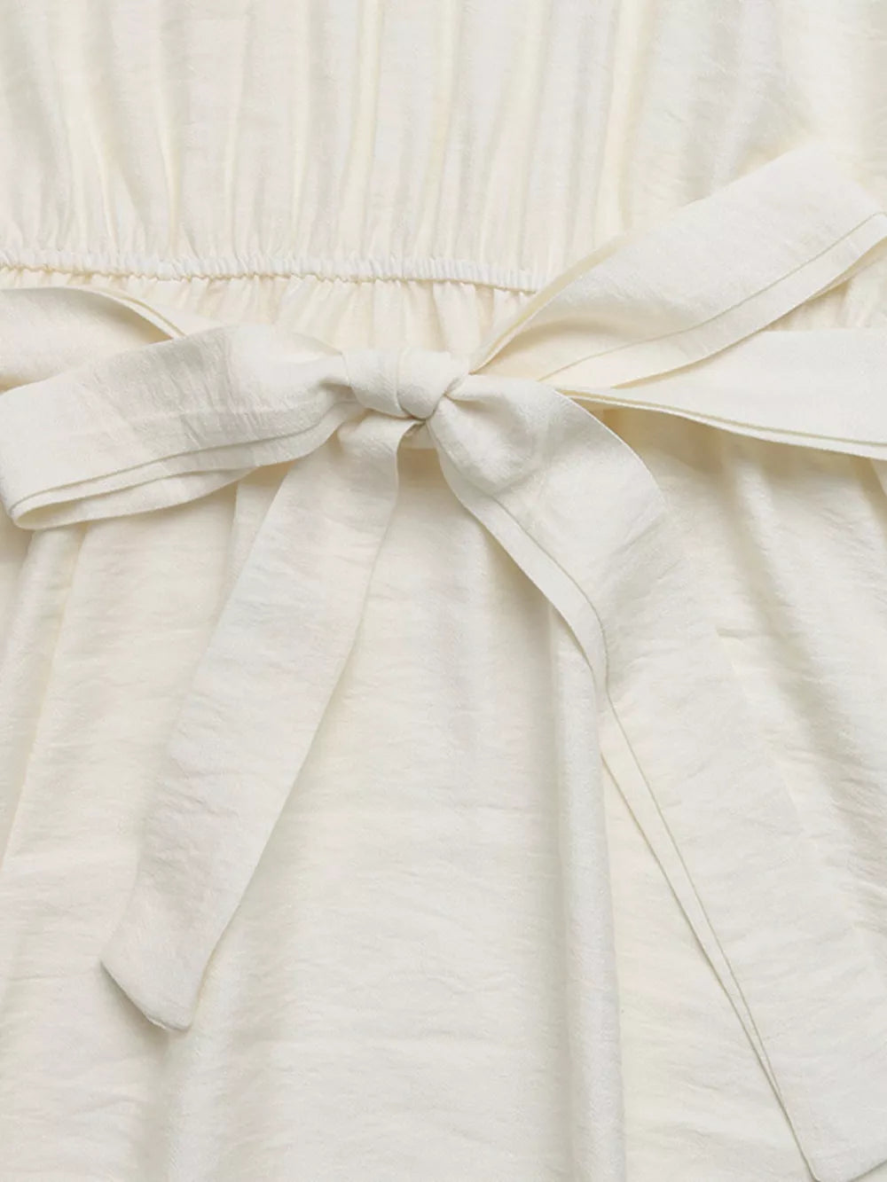 Beige maxi dress with tie waist and textured fabric detail