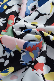 Dalmatian Trim Floral Print Blouse in black and light blue with abstract floral pattern.