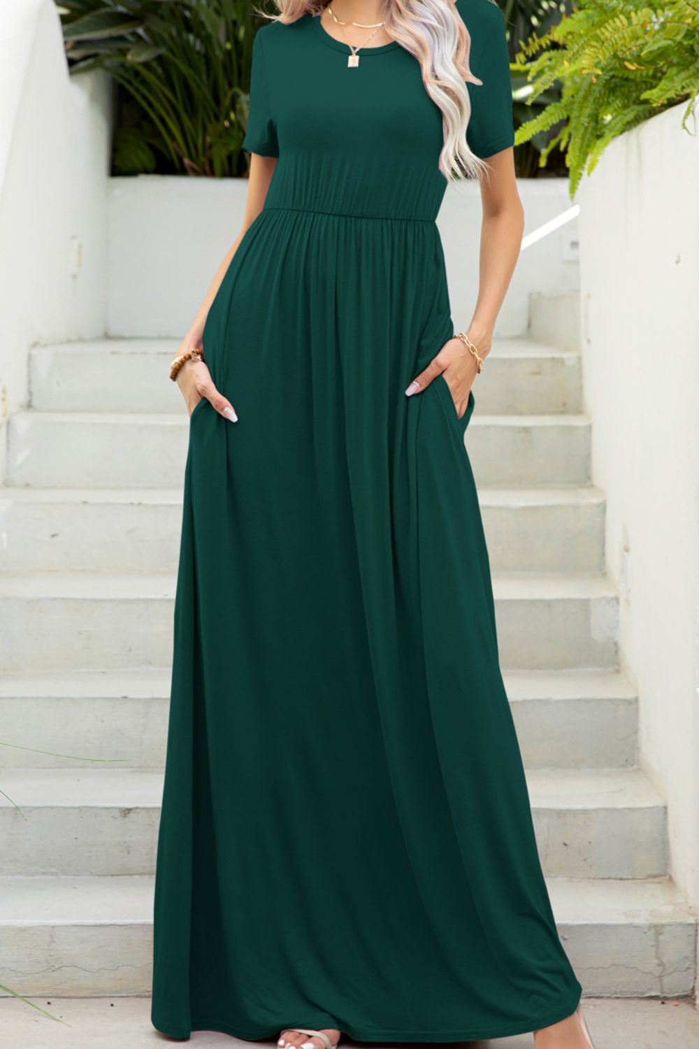 Forest green maxi dress with short sleeves, gathered waist, and pockets.