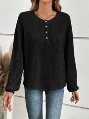 Black textured henley blouse with button detail and blouson sleeves.