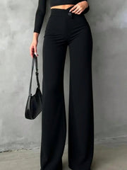Black buttoned high-waist wide-leg trousers with a single button detail.