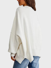 White oversized ribbed knit sweater with drop shoulders and a relaxed fit.