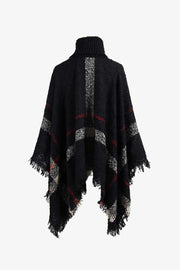 Black plaid turtleneck cape with fringe detail and textured acrylic knit.
