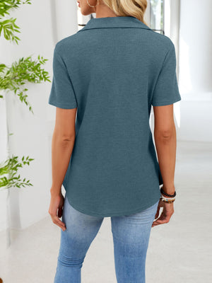 Peacock blue waffle knit button placket t-shirt with collared neckline and short sleeves.