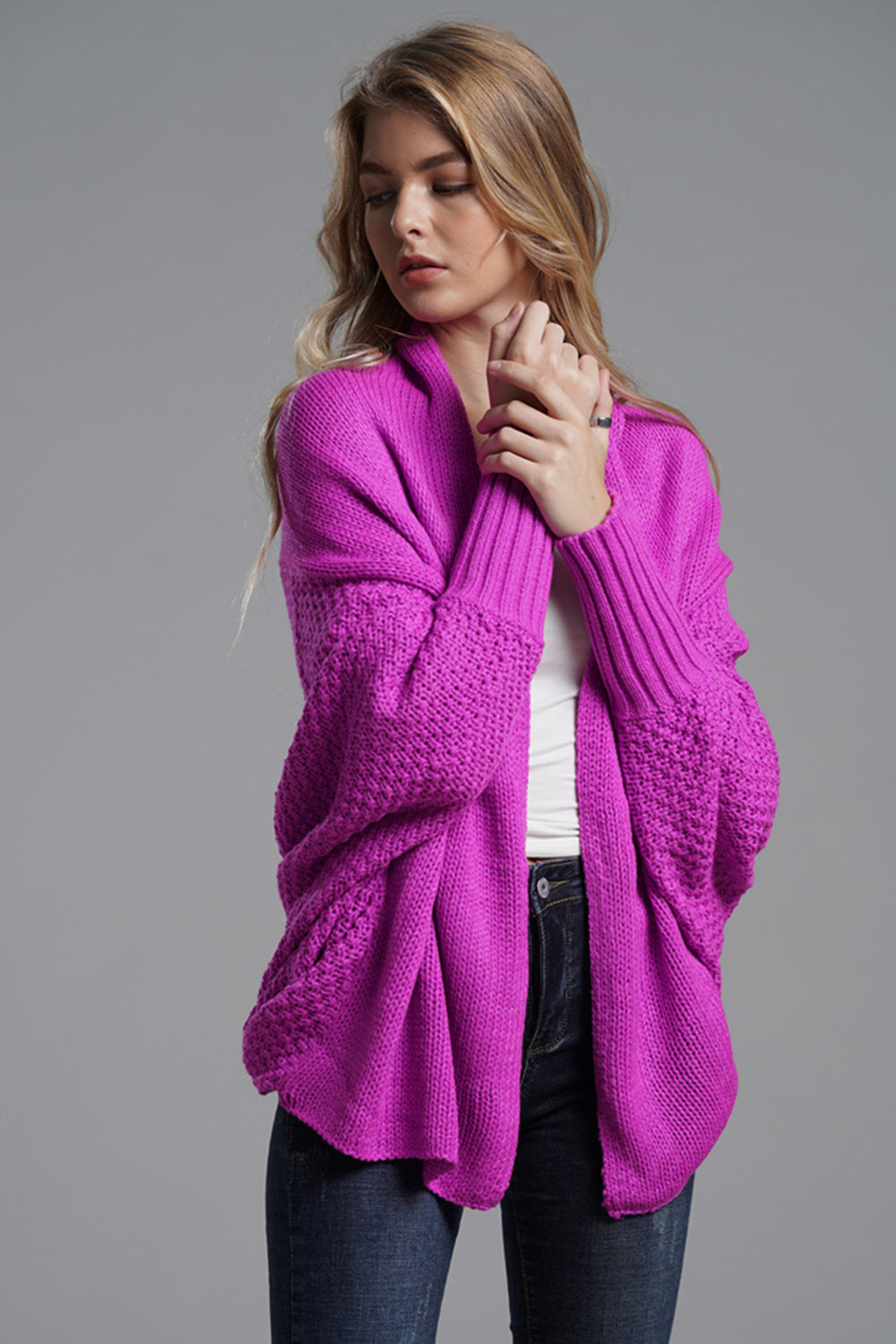 Cocoon knit sleeve cardigan in vivid violet acrylic with textured sleeves and ribbed cuffs.