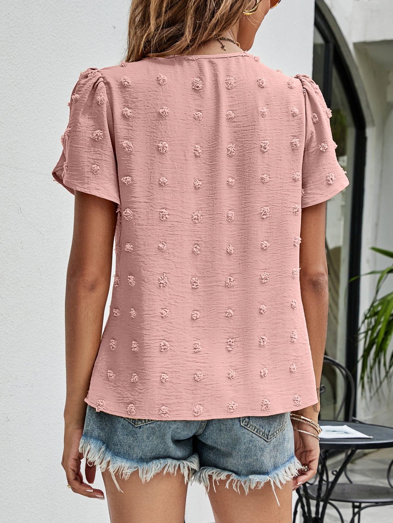 Pink textured puff sleeve dot blouse with short sleeves and a casual cut.