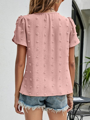 Pink textured puff sleeve dot blouse with short sleeves and a casual cut.