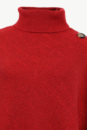 Deep red acrylic turtleneck poncho with button detail on shoulder