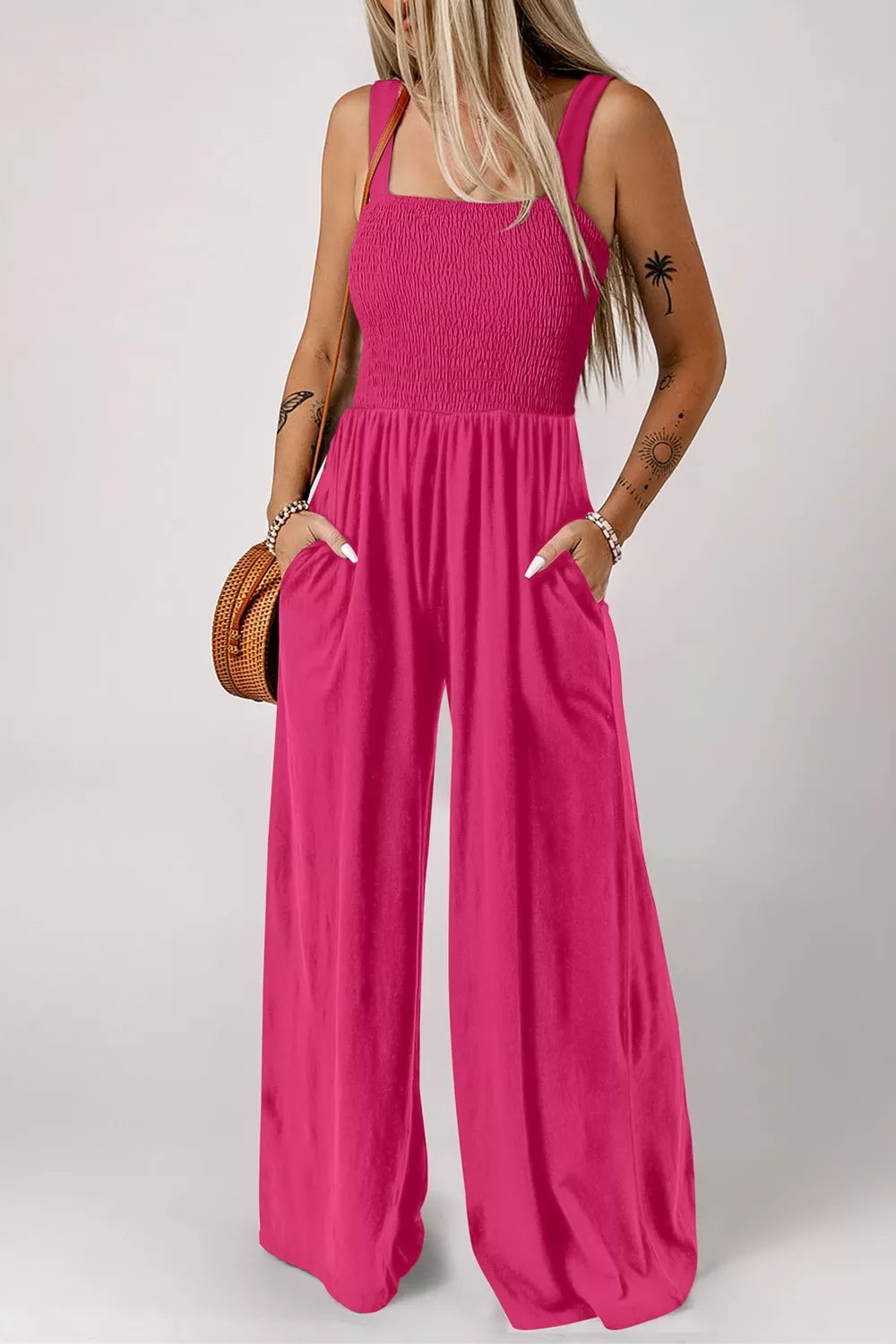 Pink smocked bodice wide-leg romper with square neckline and pockets