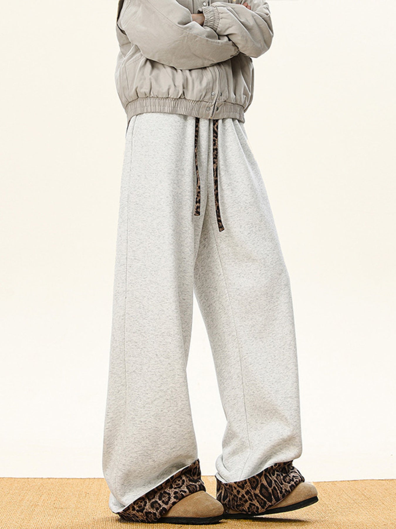 Men's gray wide-leg sweatpants with leopard print trim on drawstring and cuffs.