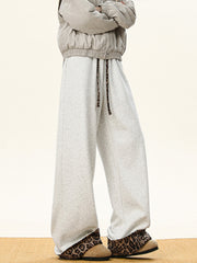 Men's gray wide-leg sweatpants with leopard print trim on drawstring and cuffs.