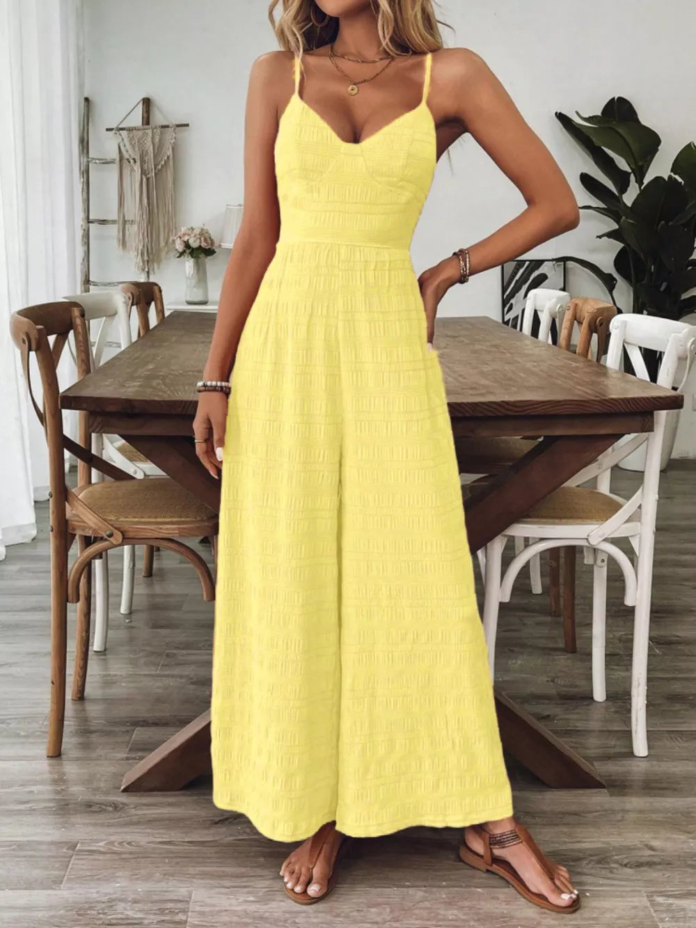 Yellow maternity romper with wide legs and textured fabric.