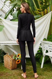 Black long sleeve swimsuit with flounce hem and full length leggings.